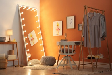 Photo of Trendy mirror with light bulbs in stylish room interior