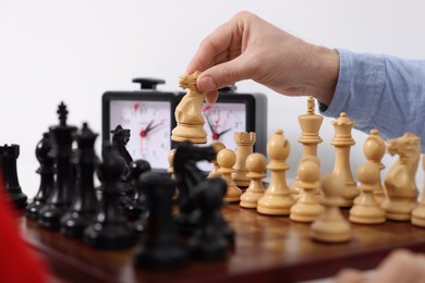 Man playing chess at table indoors, closeup