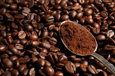 Spoon with ground coffee on roasted beans, closeup. Space for text