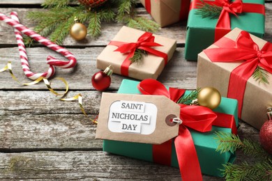 Photo of Saint Nicholas Day. Gift boxes and festive decor on wooden table