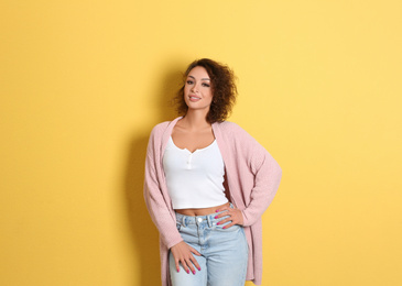 Beautiful woman in casual outfit on yellow background