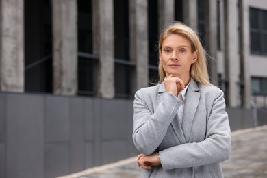 Photo of Portrait of thoughtful woman outdoors, space for text. Lawyer, businesswoman, accountant or manager