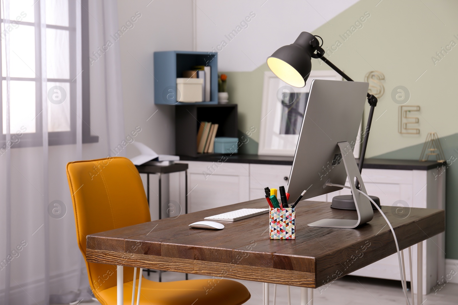 Photo of Comfortable workplace with computer on desk in home office