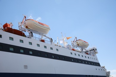 Modern ferry with lifeboats on sunny day, low angle view