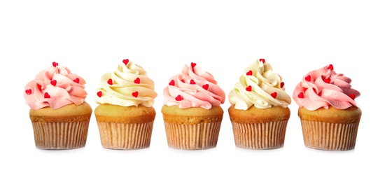 Row of tasty cupcakes for Valentine's Day on white background