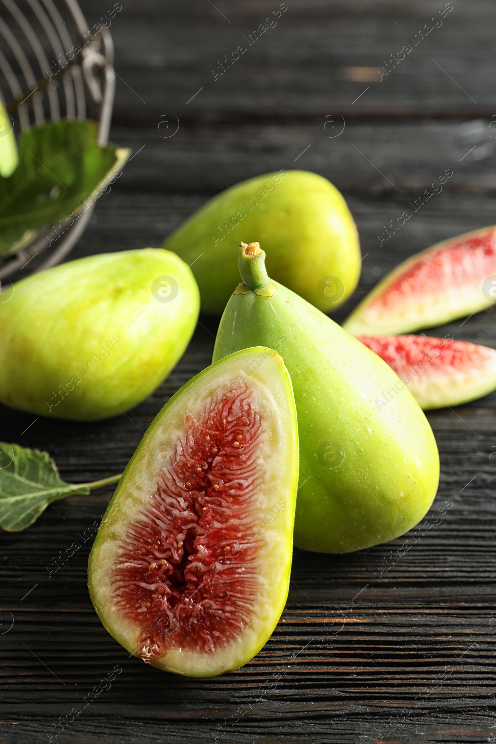 Photo of Fresh ripe figs on wooden table. Tropical fruit