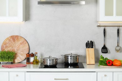 Photo of Countertop with different cooking utensils and ingredients in kitchen