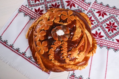 Photo of Korovai on rushnyk, top view. Ukrainian bread and salt welcoming tradition