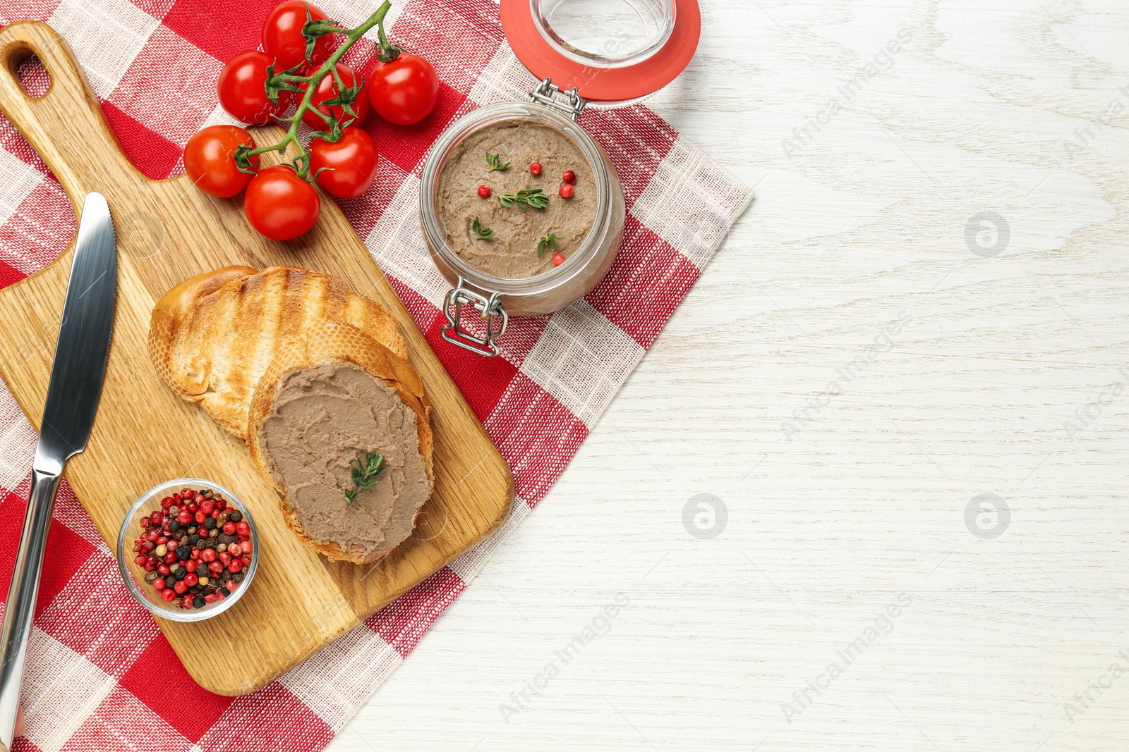 Photo of Fresh bread with delicious liver pate on white wooden table, flat lay. Space for text