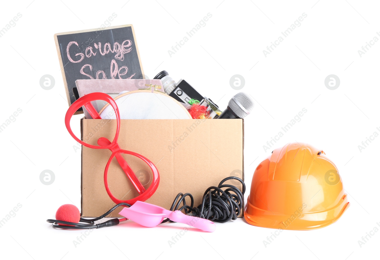 Photo of Box of unwanted stuff isolated on white. Garage sale