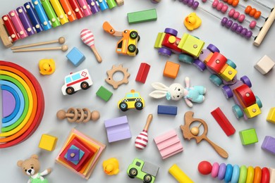 Photo of Different children's toys on light grey background, flat lay