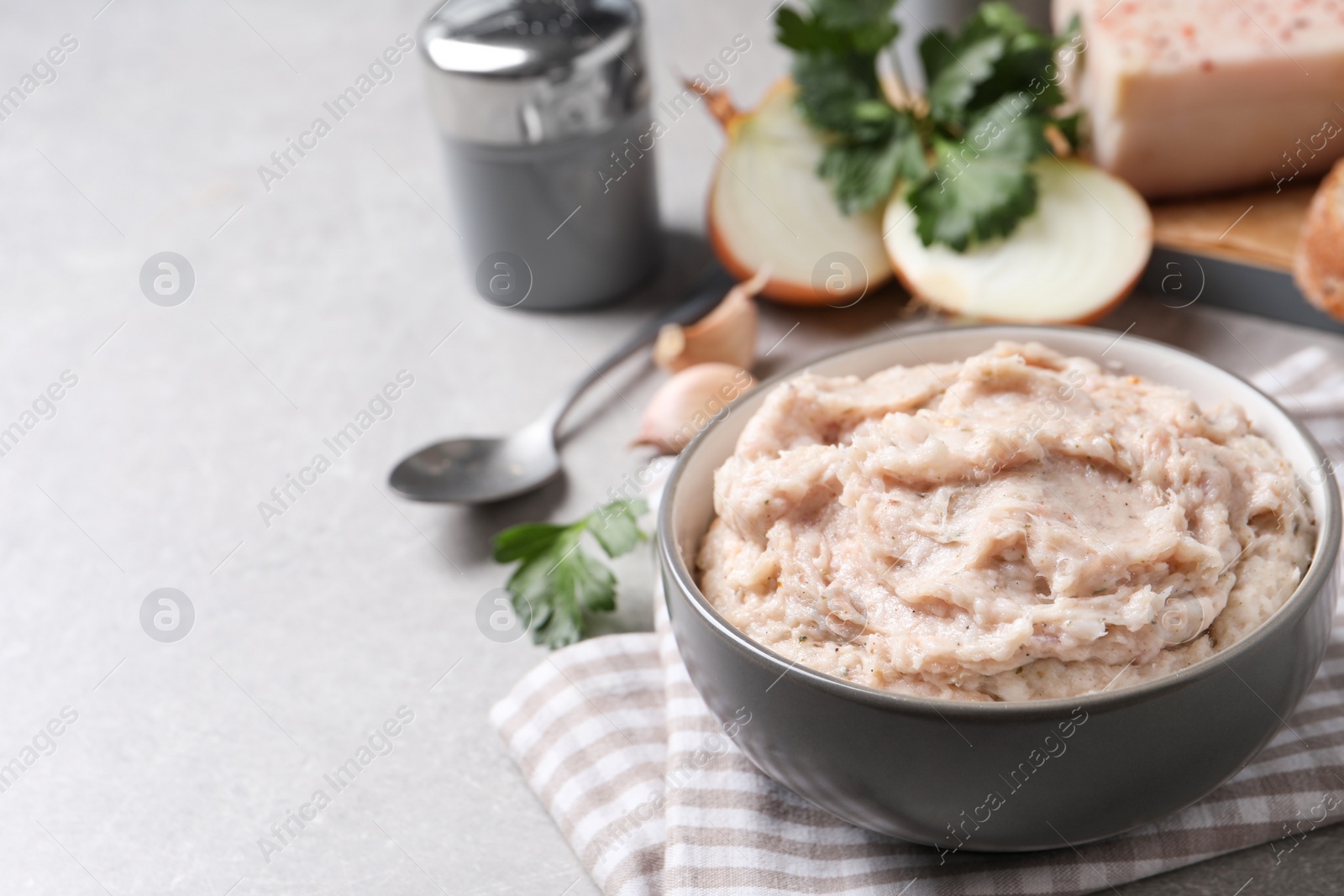 Photo of Delicious lard spread in bowl on light table. Space for text