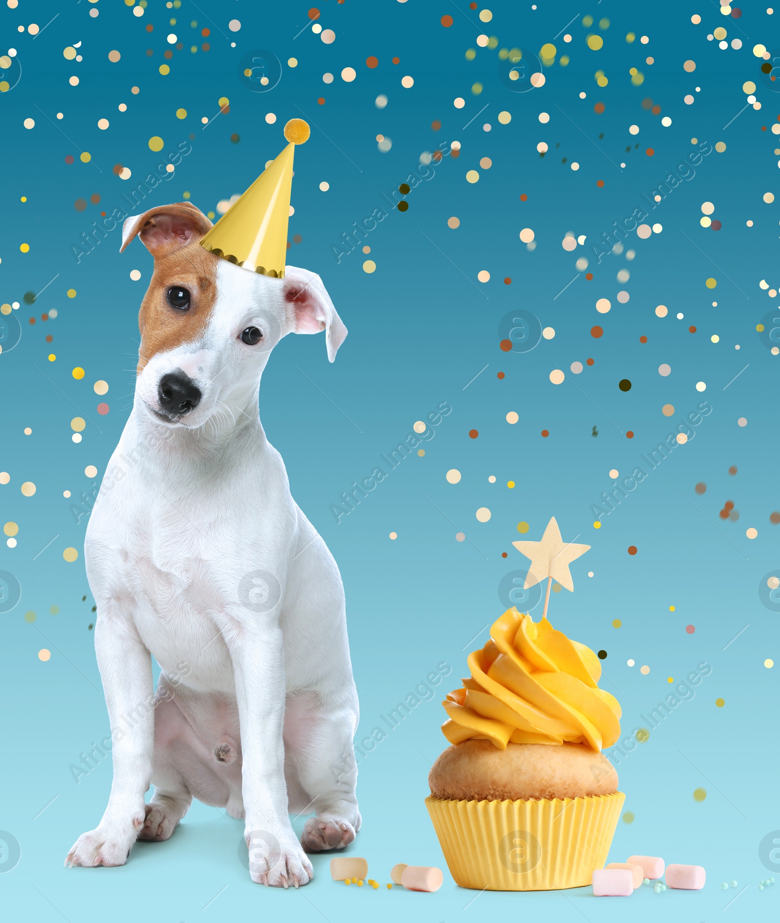 Image of Cute dog with party hat and delicious birthday cupcake on light blue background