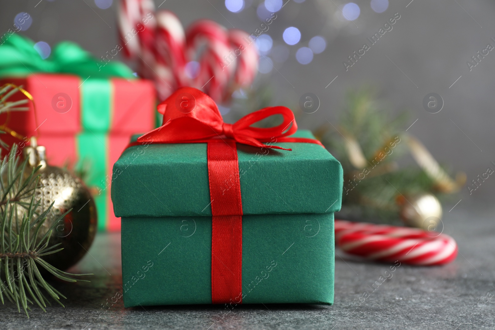 Photo of Gift boxes and Christmas decorations on grey textured table