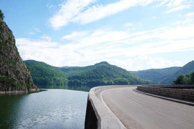 Photo of Beautiful view of road along lake on sunny day