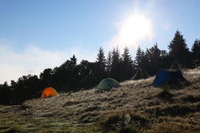 Photo of Picturesque mountain landscape with camping tents in morning