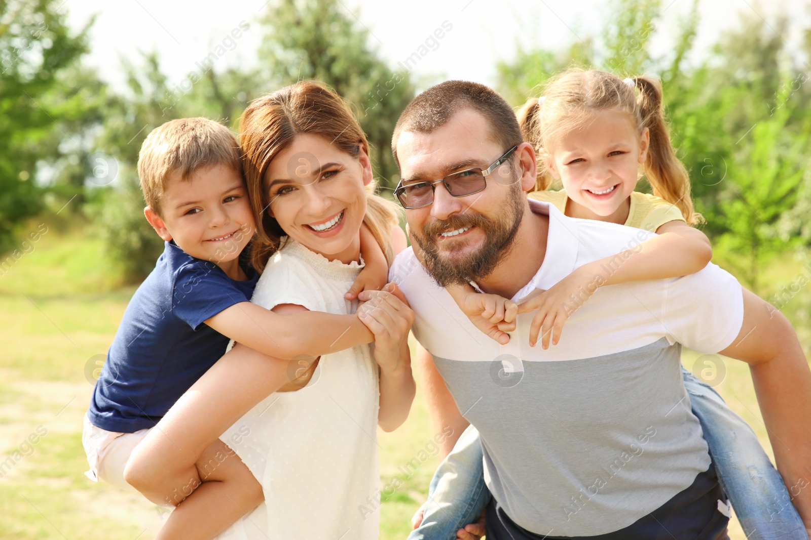 Photo of Happy family spending time together with their children outdoors