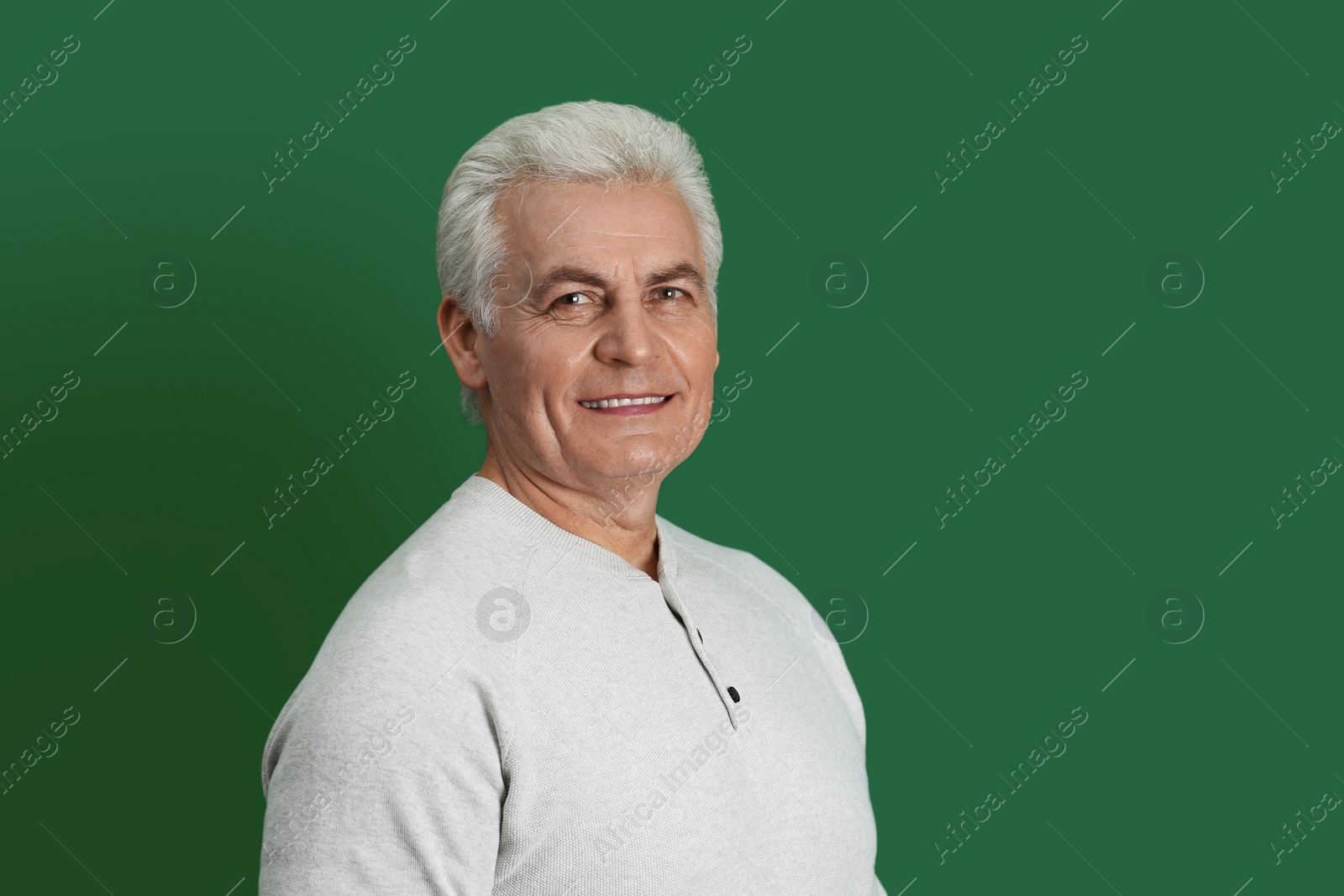 Photo of Portrait of handsome mature man on color background. Space for text