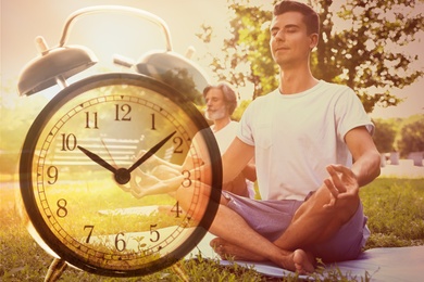 Image of Time to do morning exercises. Double exposure of people practicing yoga in park and alarm clock