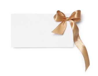 Photo of Blank gift card with golden bow isolated on white, top view
