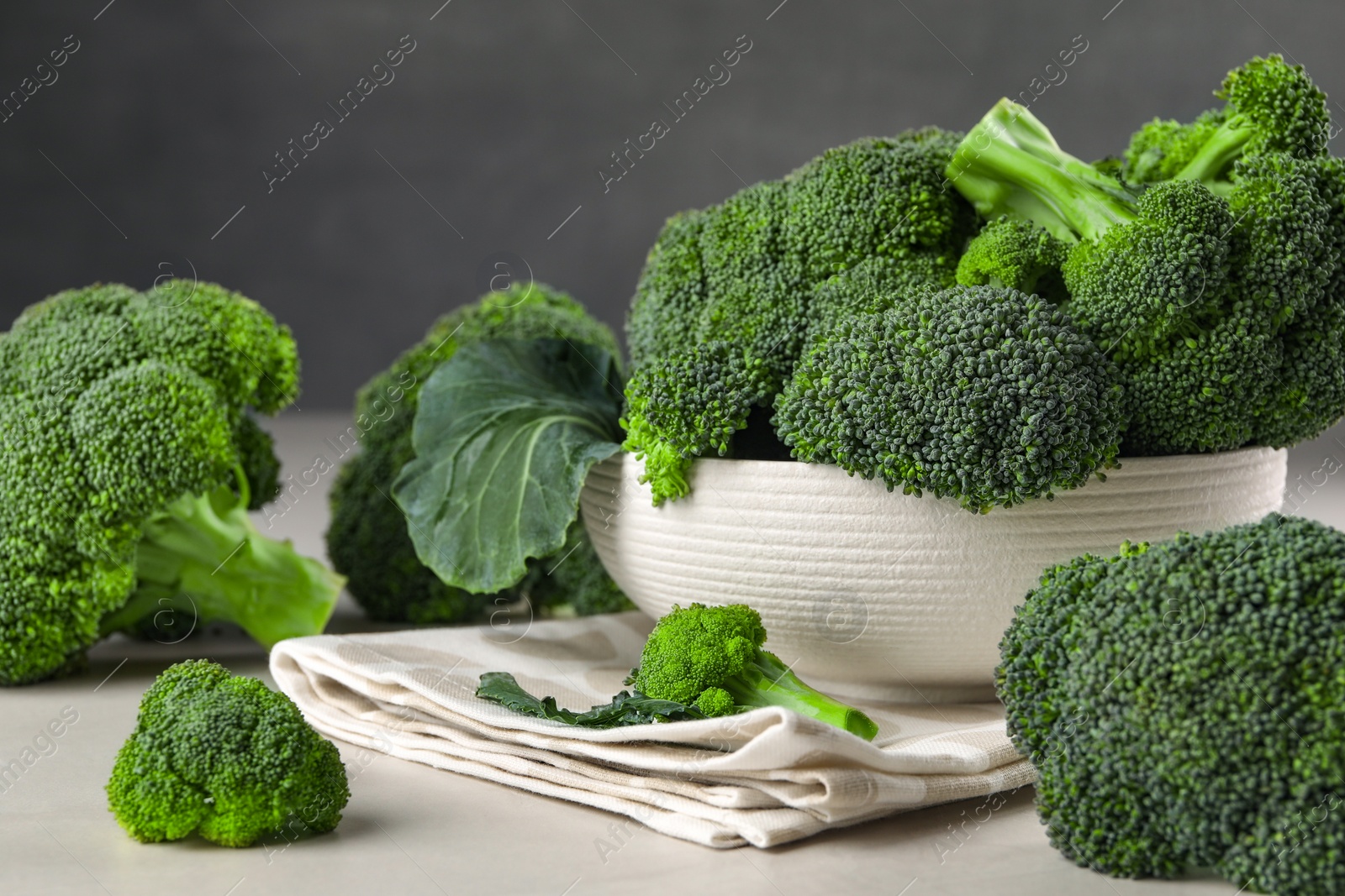 Photo of Fresh raw broccoli on white table, closeup