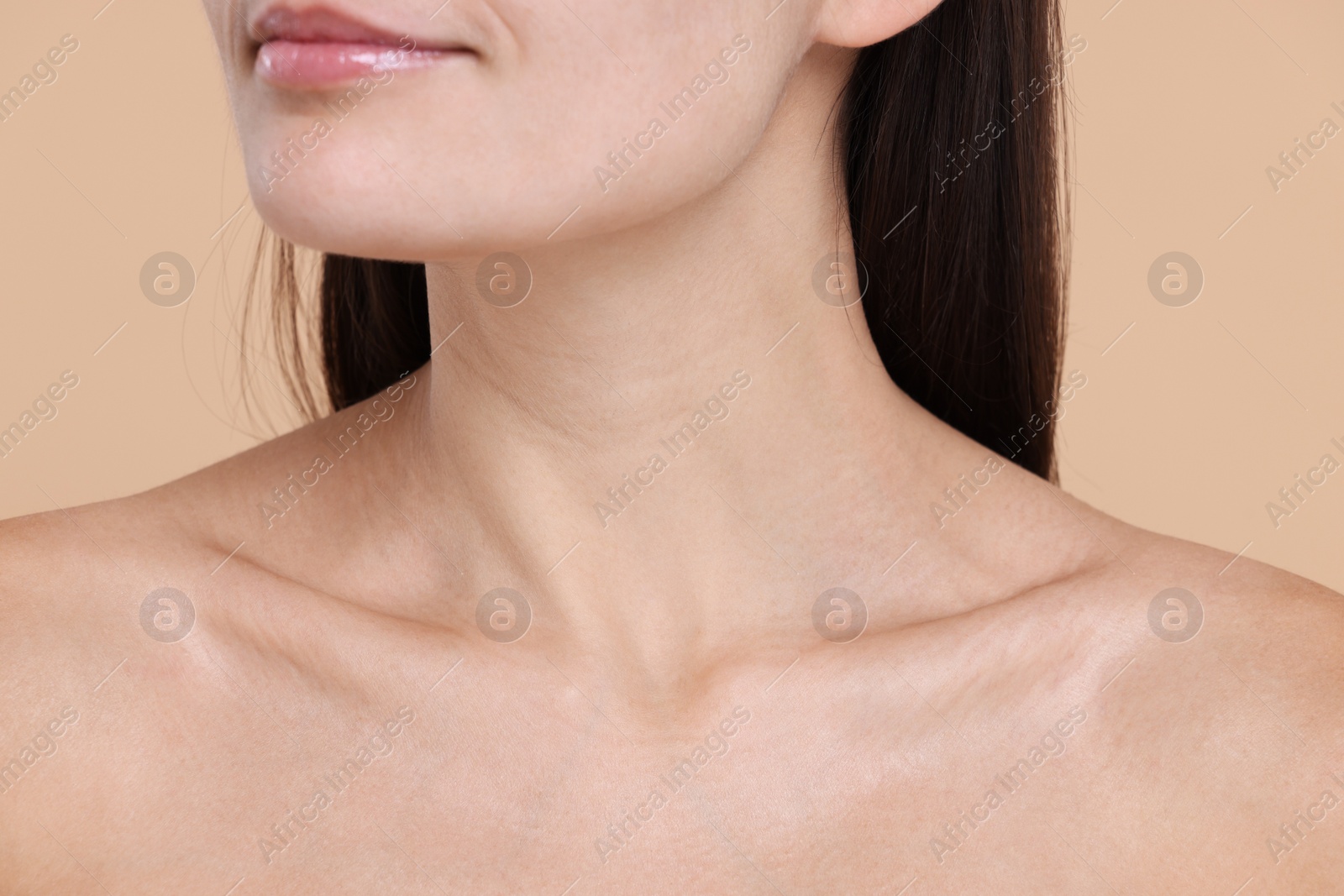 Photo of Closeup view of woman with healthy skin on beige background