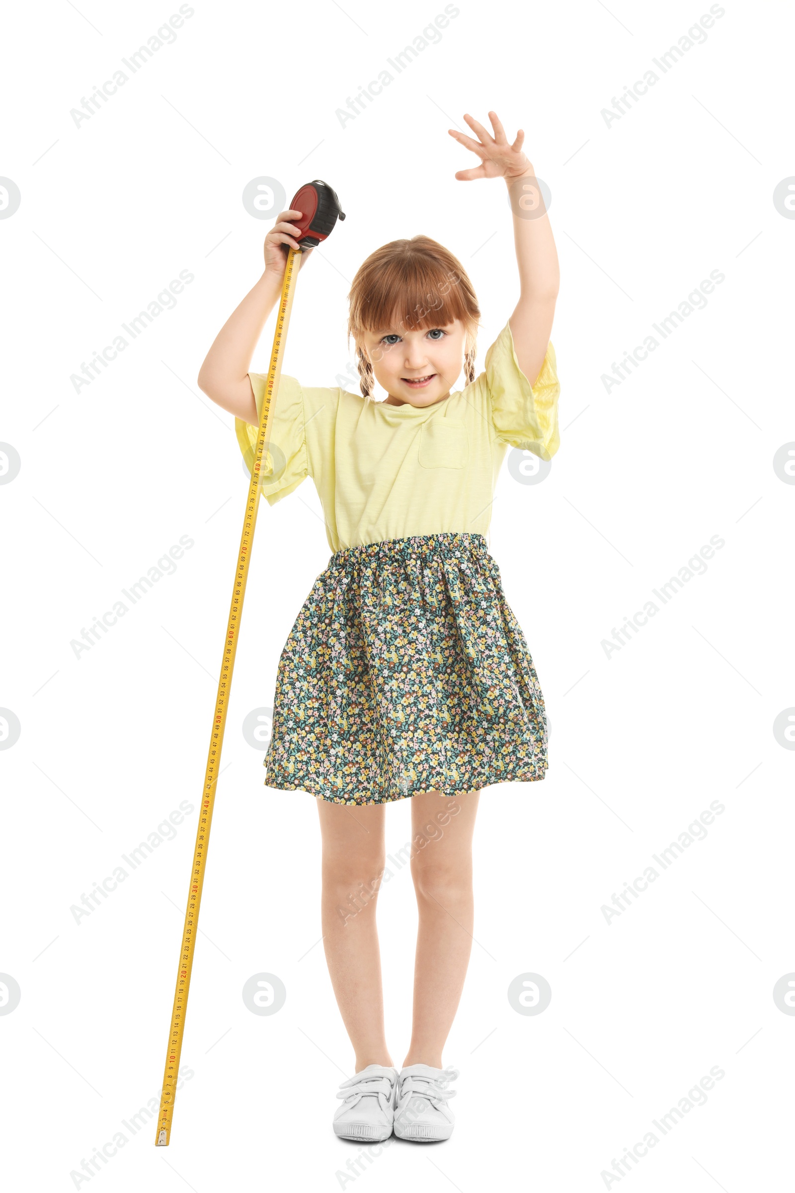 Photo of Little girl measuring her height on white background