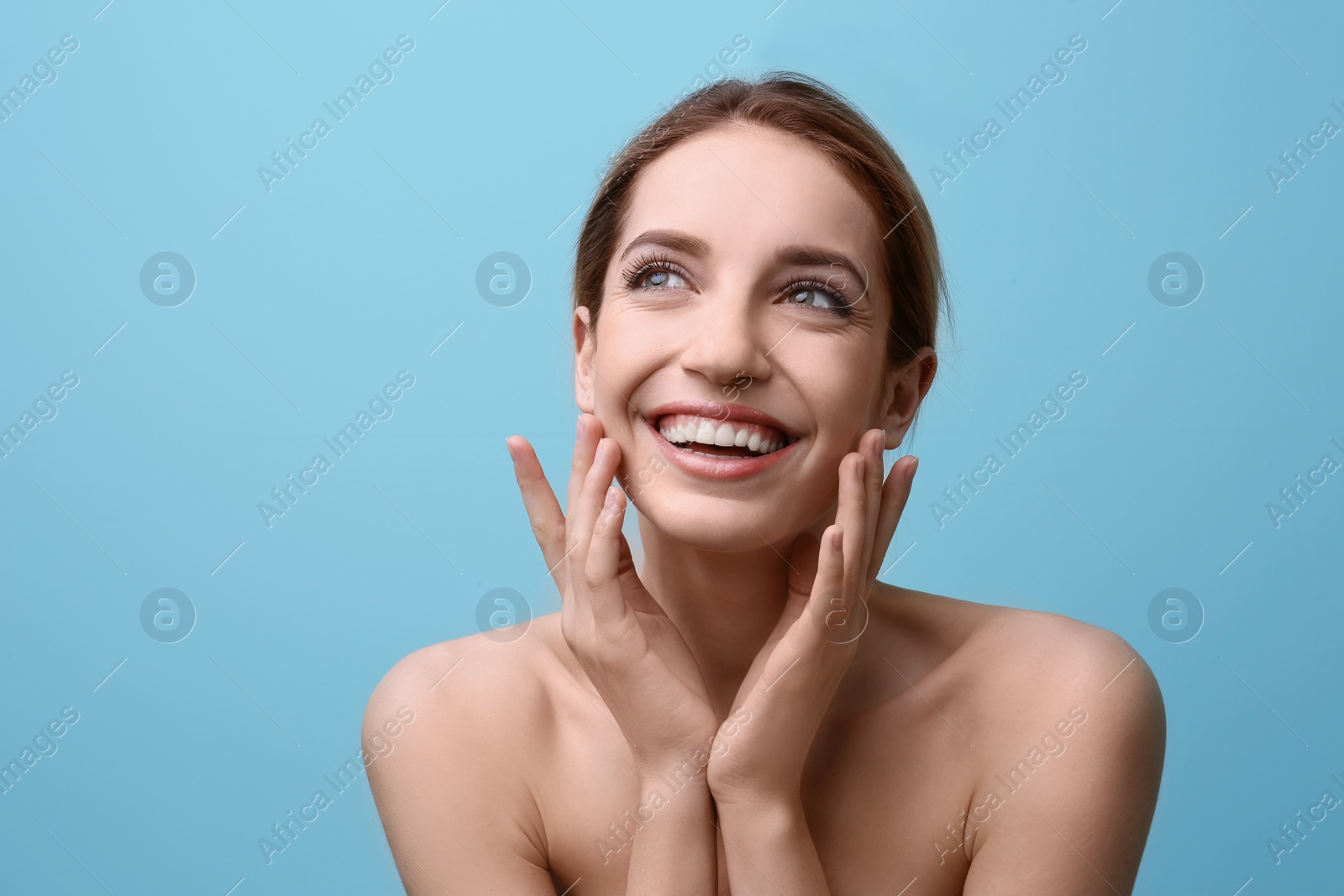 Photo of Beautiful young woman with silky skin on color background