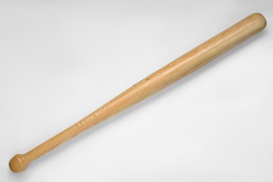 Photo of Wooden baseball bat on white background, top view. Sports equipment