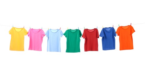 Colorful t-shirts drying on washing line isolated on white