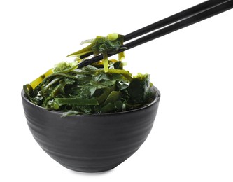 Photo of Fresh laminaria (kelp) seaweed in bowl and chopsticks on white background