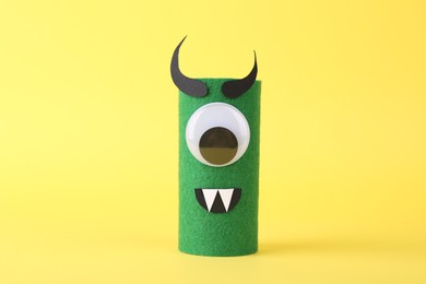 Spooky monster on yellow background. Handmade Halloween decoration