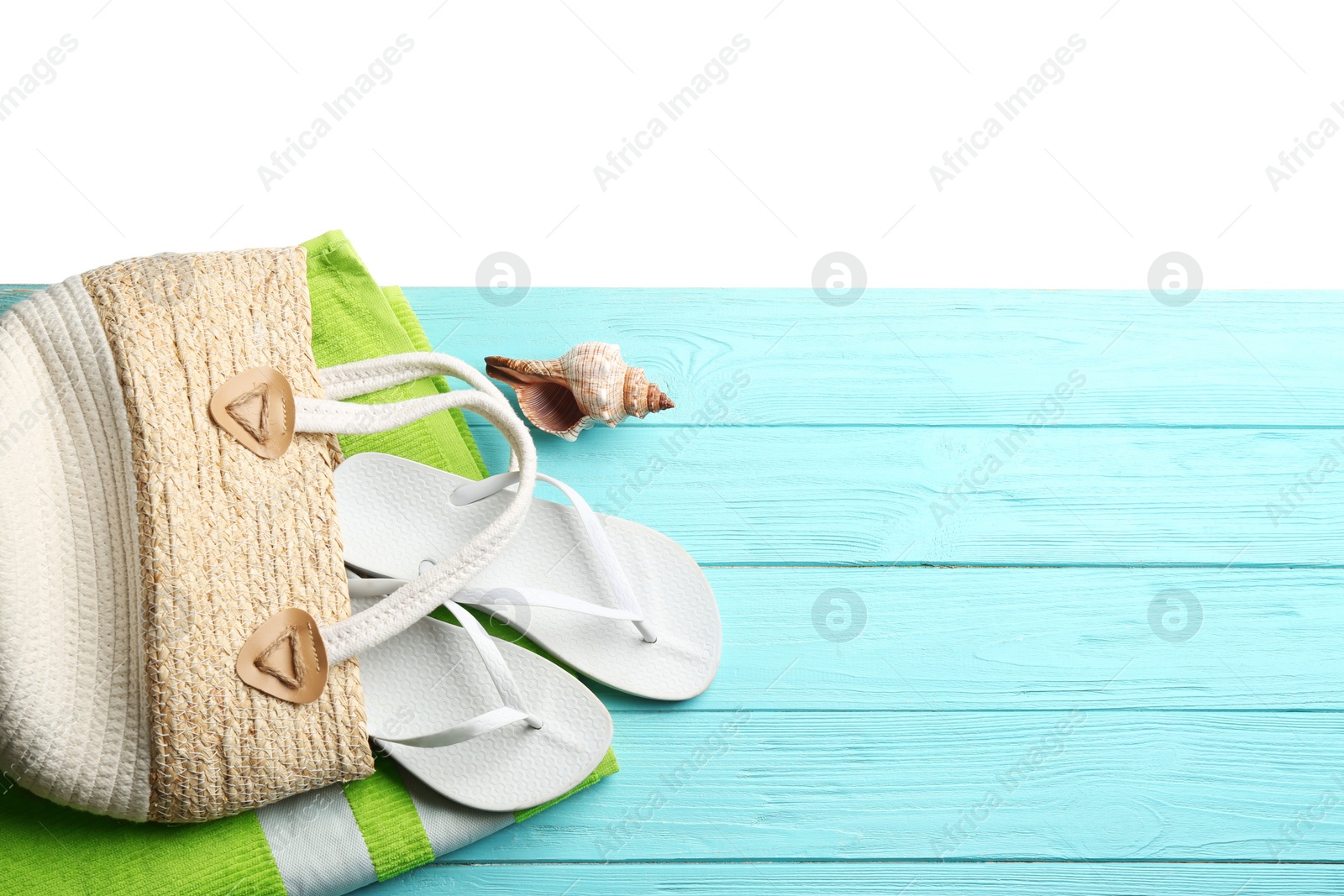 Photo of Beach accessories on light blue wooden table, flat lay. Space for text