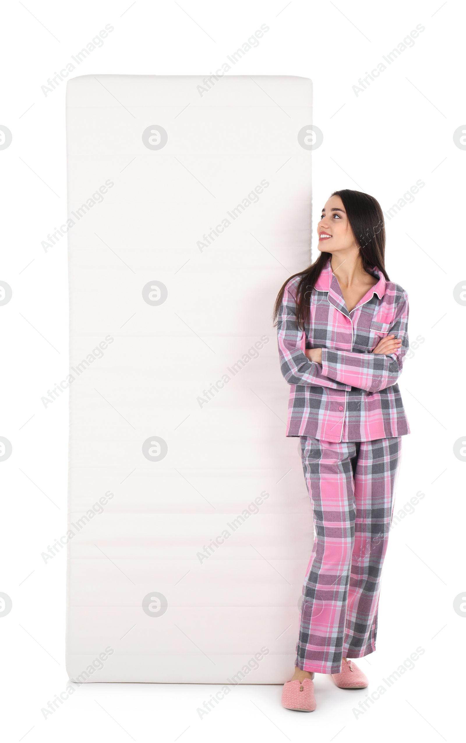 Photo of Young woman with comfortable mattress isolated on white