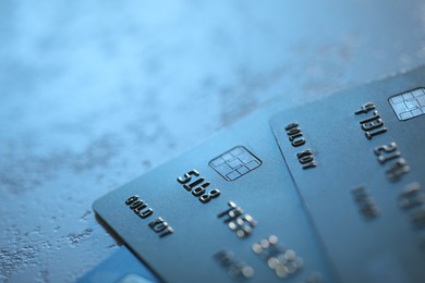 Photo of Plastic credit cards on table, closeup view. Space for text