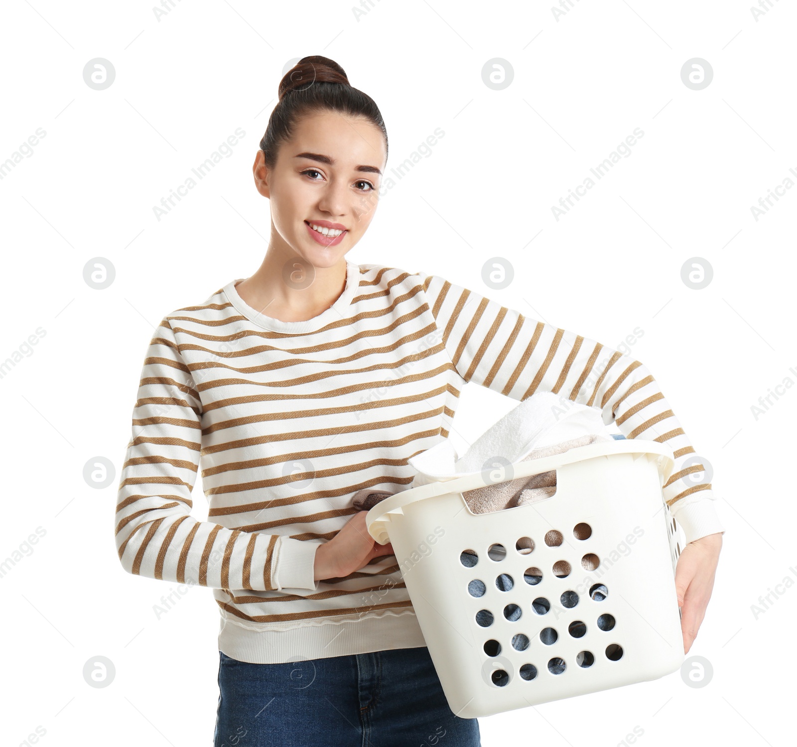 Photo of Happy young woman holding basket with laundry on white background