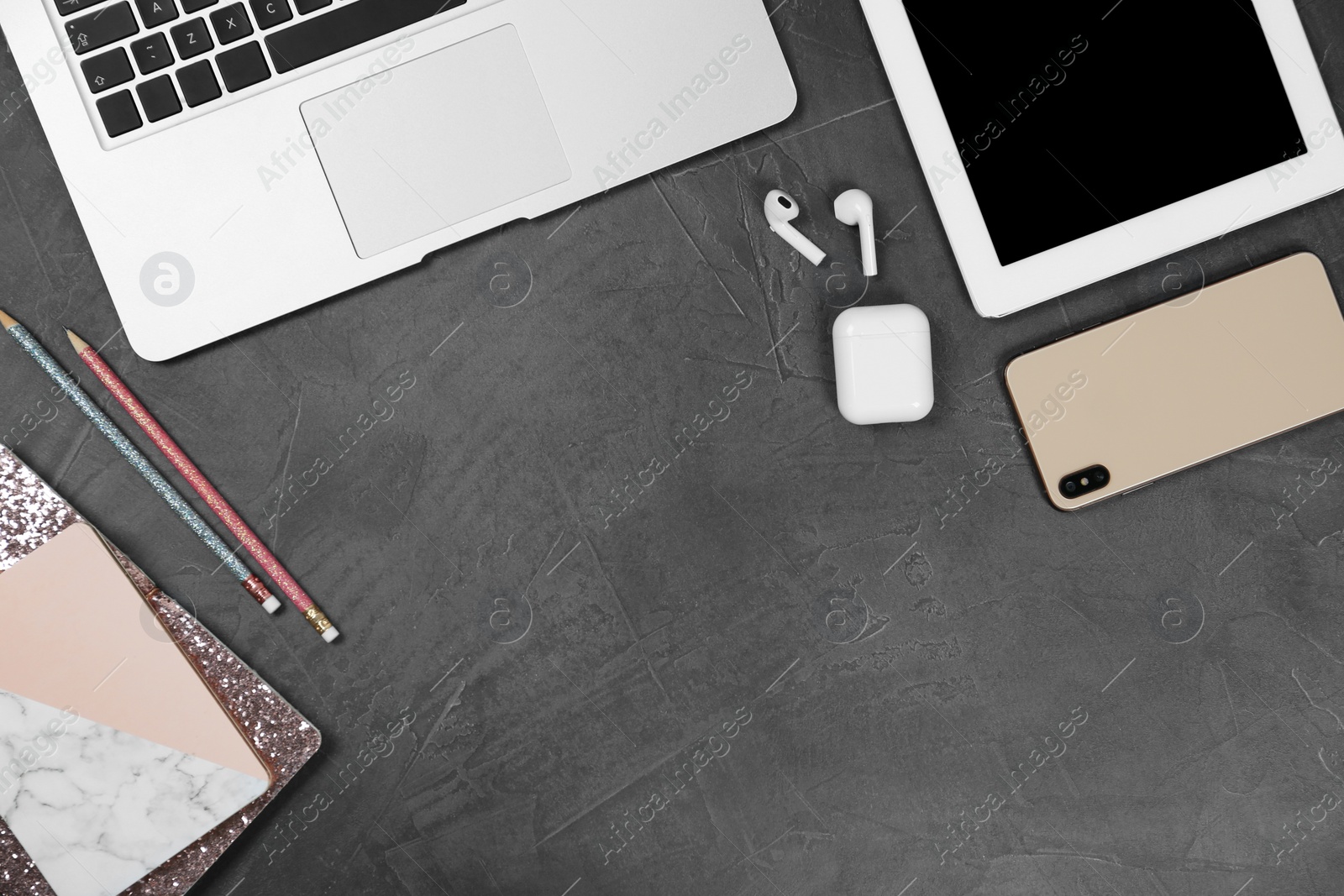 Photo of Flat lay composition with phone and tablet on grey stone table, space for text. Designer's workplace