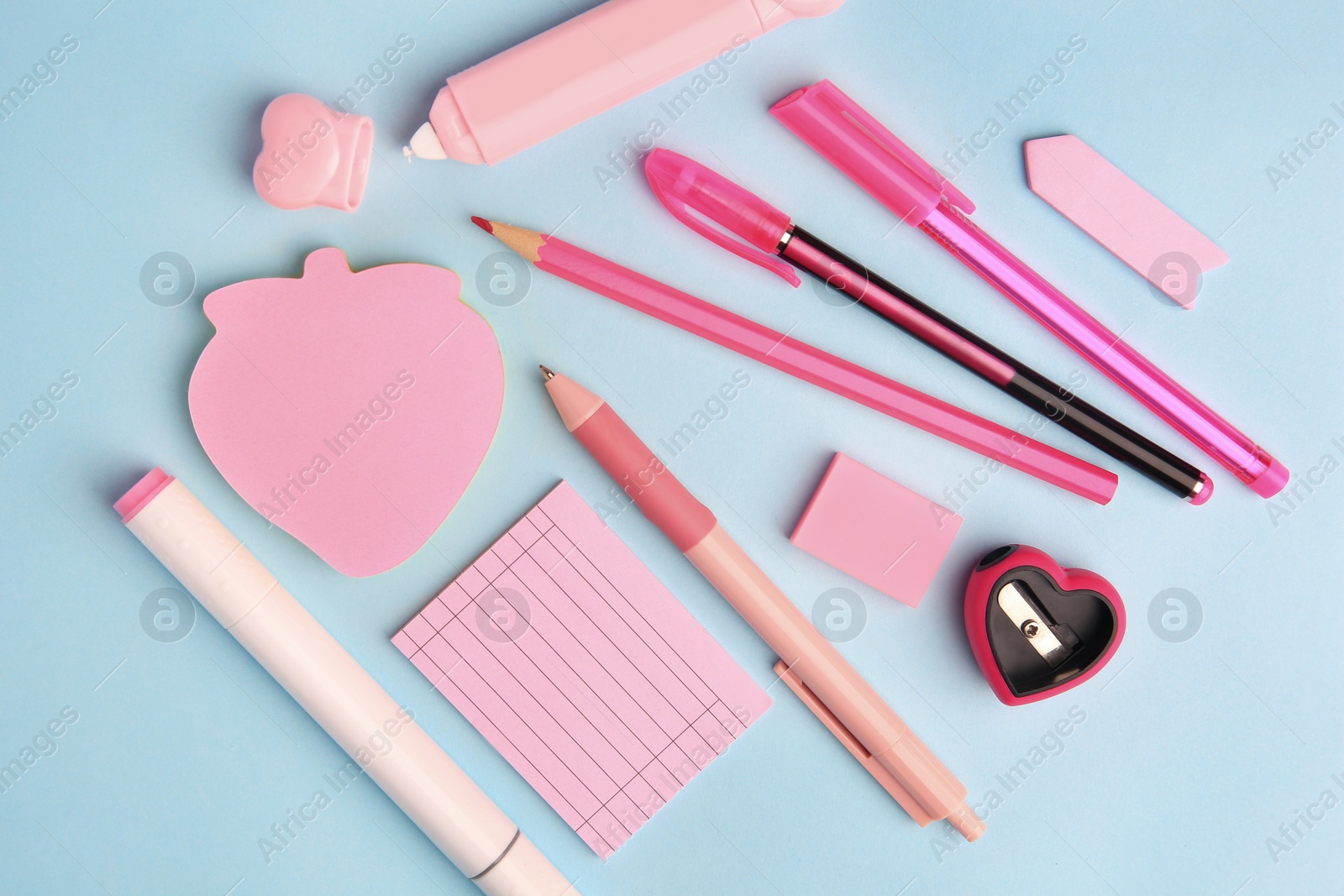 Photo of Flat lay composition with sticky note and other school stationery on light blue background, space for text. Back to school