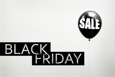 Black Friday. Balloon with word SALE on light background 