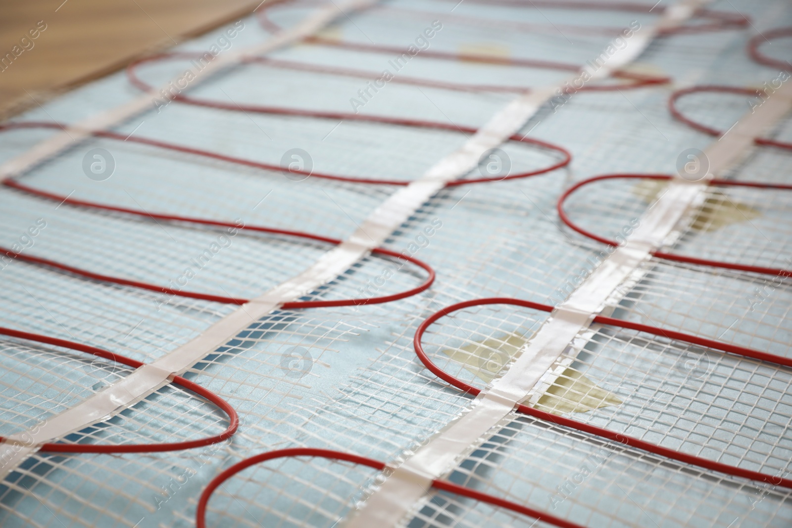 Photo of Installation of electric underfloor heating system indoors, closeup