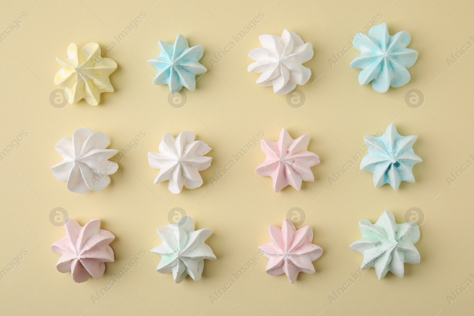 Photo of Delicious meringue cookies on beige background, flat lay