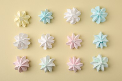 Photo of Delicious meringue cookies on beige background, flat lay