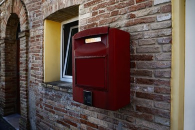 Photo of Red letter box on brick wallbuilding