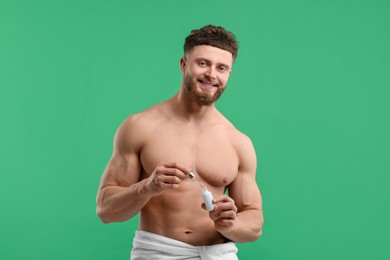 Photo of Handsome man with serum on green background