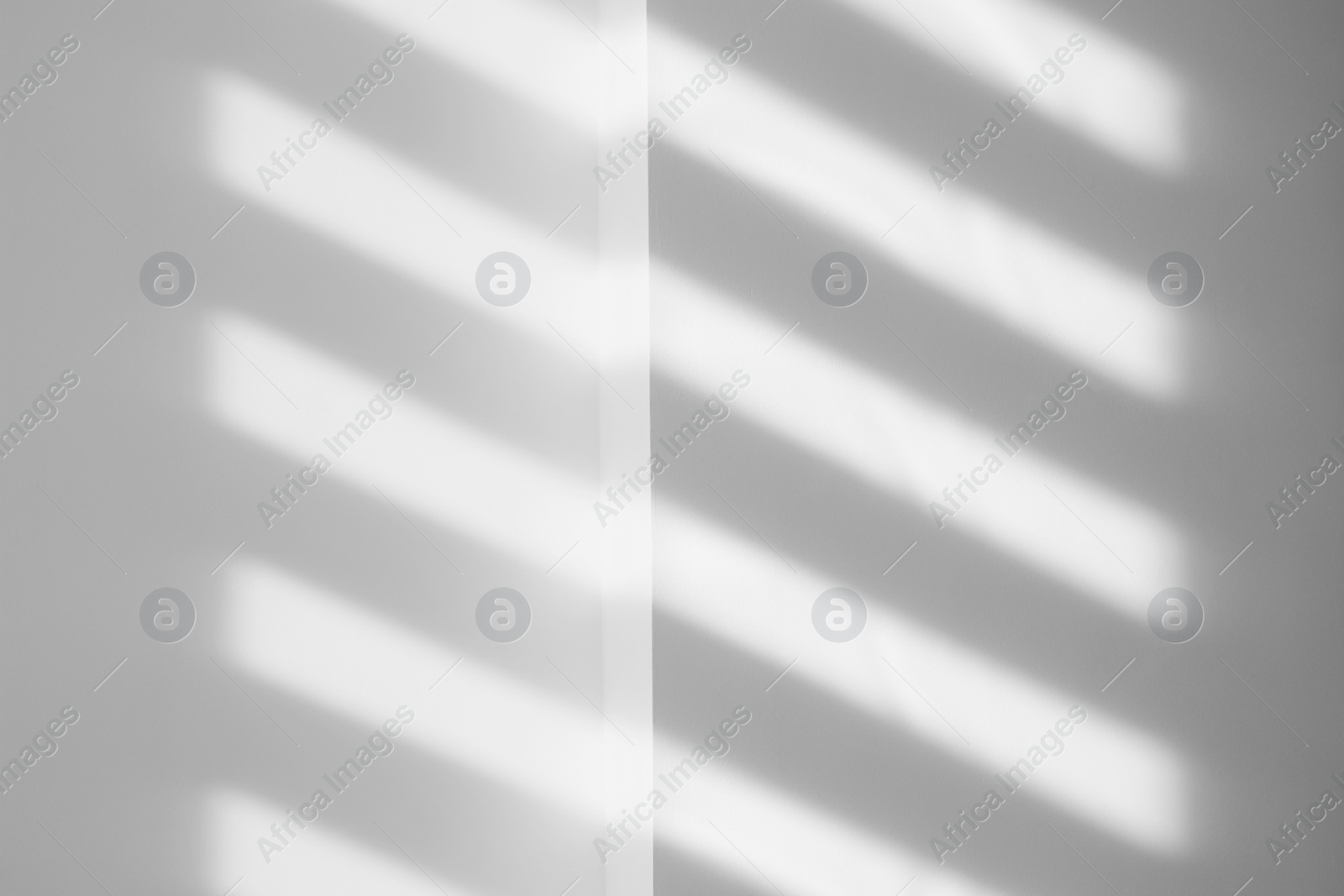 Image of Light and shadows falling on white wall