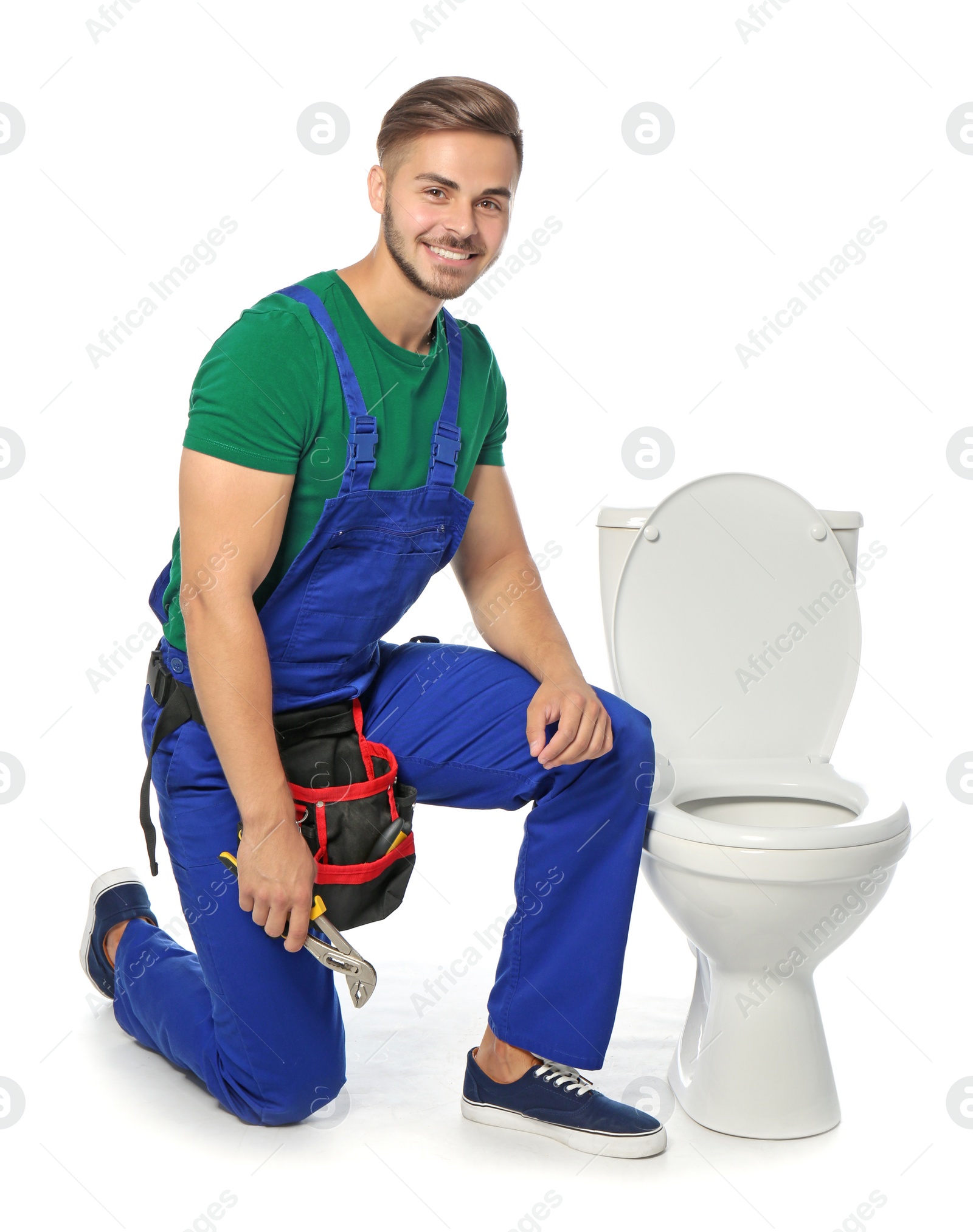 Photo of Young man working with toilet bowl, isolated on white