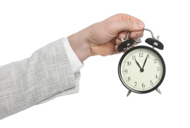 Photo of Businessman holding alarm clock on white background, closeup. Time management