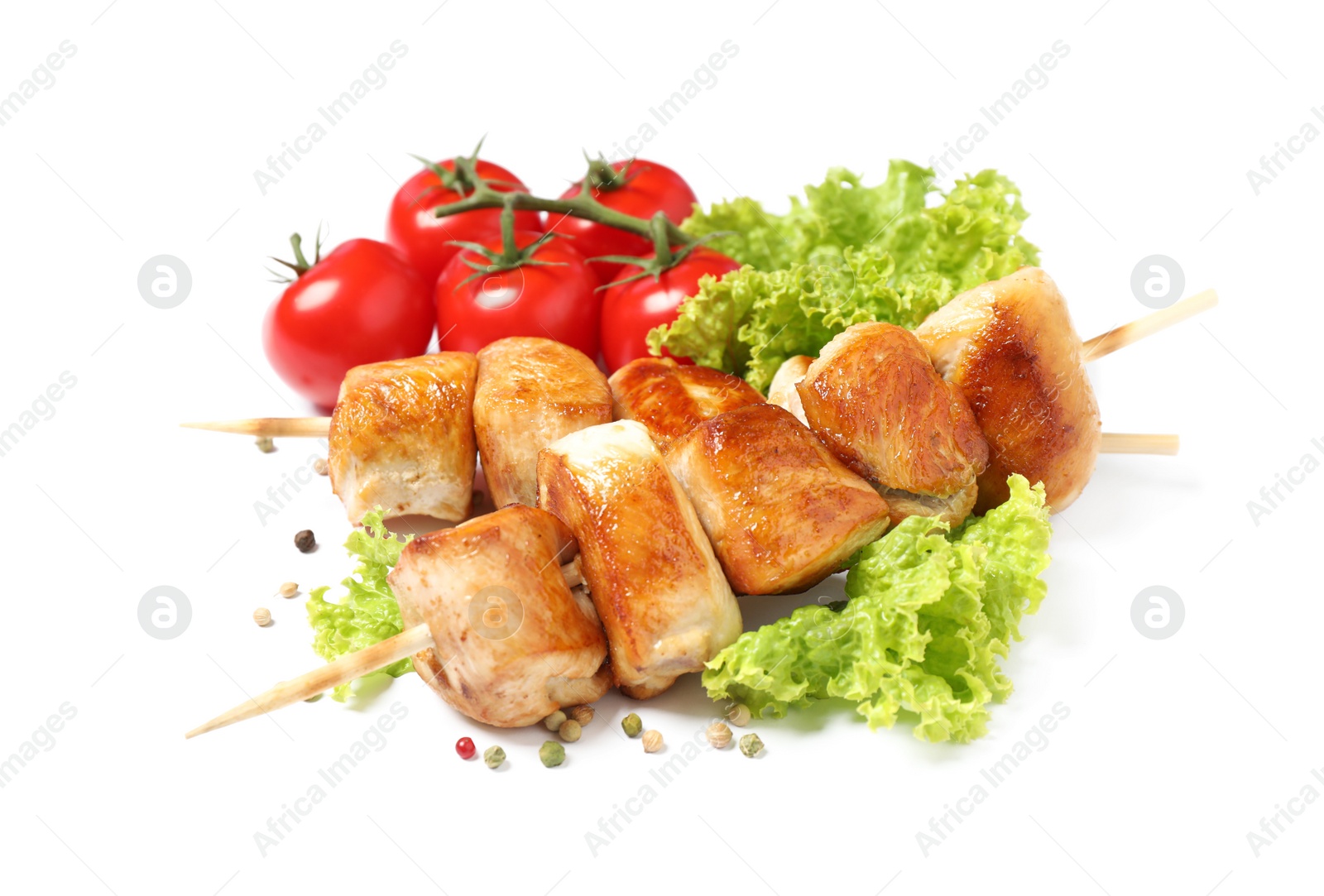 Photo of Delicious chicken shish kebabs and vegetables on white background