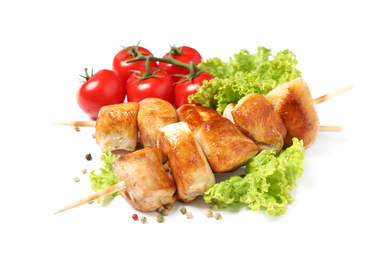 Delicious chicken shish kebabs and vegetables on white background