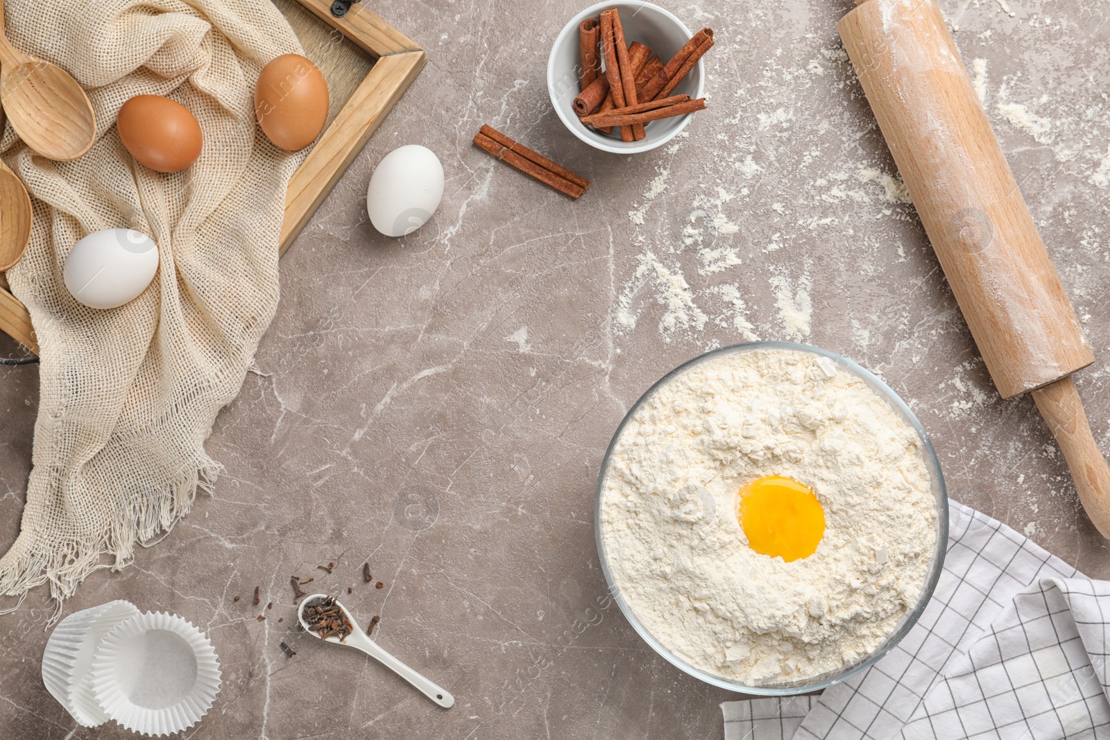 Photo of Composition with flour, eggs and spices on light background, top view